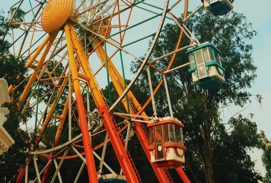 Image of Ferris wheel in beautiful dull red and burnt orange colours.